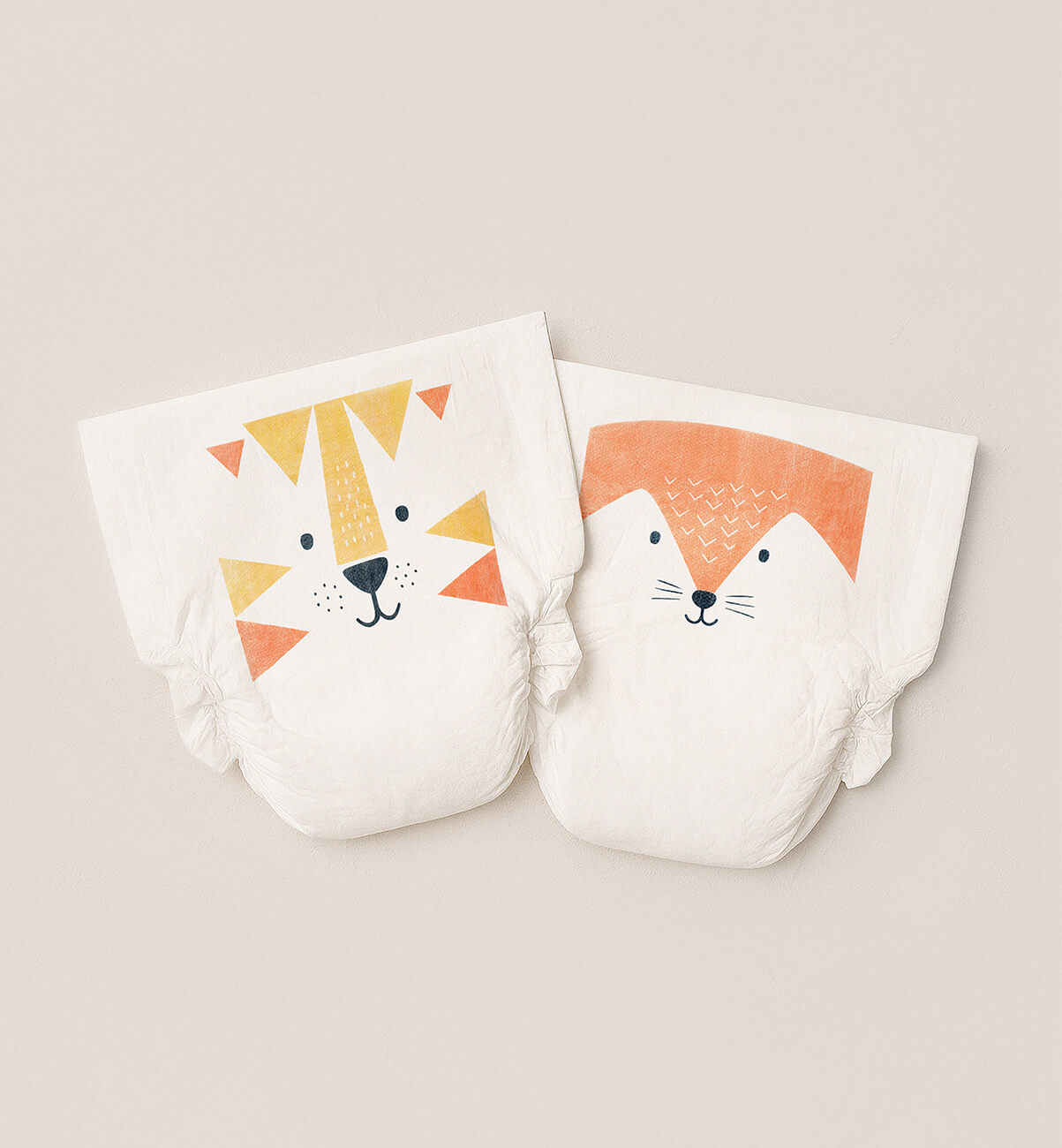 Two Kit & Kin eco nappies with lion and fox prints
